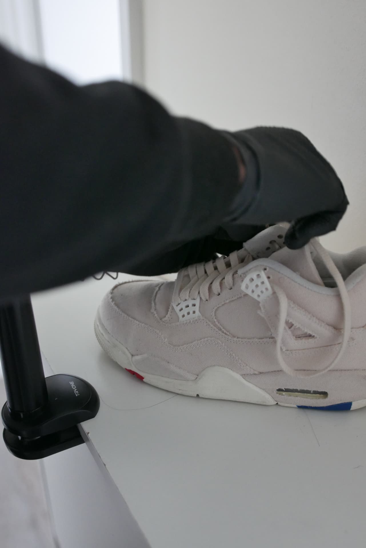 Freshly cleaned white sneaker on a studio table
